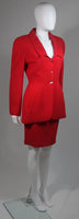 This skirt suit is composed of red fabric. The jacket has center front closures with silver hardware. The skirt has a classic pencil silhouette with zipper closure. In excellent vintage condition. Made in France.