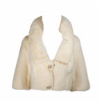 This Oleg Cassini jacket is composed of an off-white/cream hue mink. Features large rhinestone and faux pearl buttons. In excellent vintage condition, the lining does have some discoloration due to age. 