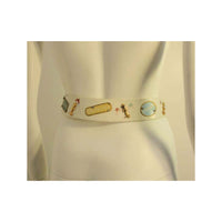 This is an adorable novelty belt that was made for Saks Fifth Avenue by Calderon. It is made of white leather and has designer names painted on it and metal dress form and rhinestone embellishments.