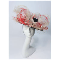 This Saks Fifth Ave. hat is composed of a black base with elastic piece for wear. Features white and red ostrich feathers. In excellent vintage condition. 