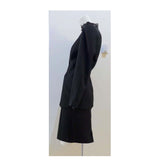 This THIERRY MUGLER skirt suit is composed of a black polyester and lace fabric. Features a classic Mugler silhouette with nipped waist and curved bust-line to neckline design. The jacket has front snap closures, rounded shoulders, and lace panels at the neck, back, and sleeves. The classic pencil style skirt features a zipper closure. In good vintage pre-owned condition. Made in France.Measurements in Inches:JacketBust: 38 Waist: 30 SkirtWaist: 27Hip: 38Length: 22