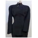 This THIERRY MUGLER skirt suit is composed of a black polyester and lace fabric. Features a classic Mugler silhouette with nipped waist and curved bust-line to neckline design. The jacket has front snap closures, rounded shoulders, and lace panels at the neck, back, and sleeves. The classic pencil style skirt features a zipper closure. In good vintage pre-owned condition. Made in France.Measurements in Inches:JacketBust: 38 Waist: 30 SkirtWaist: 27Hip: 38Length: 22