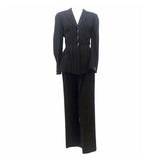 THIERRY MUGLER Black and White Stitched Pinstripe Pant Suit Size 40. This THIERRY MUGLER pant suit is composed of a wool pinstripe fabric. Features a classic Mugler silhouette with nipped waist and curved bust-line to neckline design. The jacket has front snap closures, rounded shoulders, and silver bar buttons. The classic pants features a zipper closure. In good vintage pre-owned condition. Made in France.Measurements in Inches:JacketBust: 40Waist: 32 PantsWaist: 27Hip: 40Length: 40Inseam: 29.5
