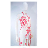 VALENTINO White with Red Coral Pattern Criss Cross Jersey Halter Dress Size 42. This Valentino gown is composed a white viscose with a red coral pattern. Features a lovely criss cross front with a body skimming design. In great pre-owned condition. **Please cross-reference measurements for personal accuracy. Size in description box is an estimation. Measures (Approximately)42Length: 54.5"Bust: 36"Waist: 32"-33"Hip: 34"-38"