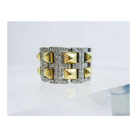 VERSACE 18 Karat White and Yellow Gold with Diamond Accents. This Versace design ring is composed of white and yellow gold, and features approximately 0.60cts of diamonds. Size 6. Please feel free to ask us any additional questions you may have.