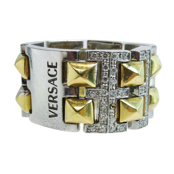 VERSACE 18 Karat White and Yellow Gold with Diamond Accents. This Versace design ring is composed of white and yellow gold, and features approximately 0.60cts of diamonds. Size 6. Please feel free to ask us any additional questions you may have.