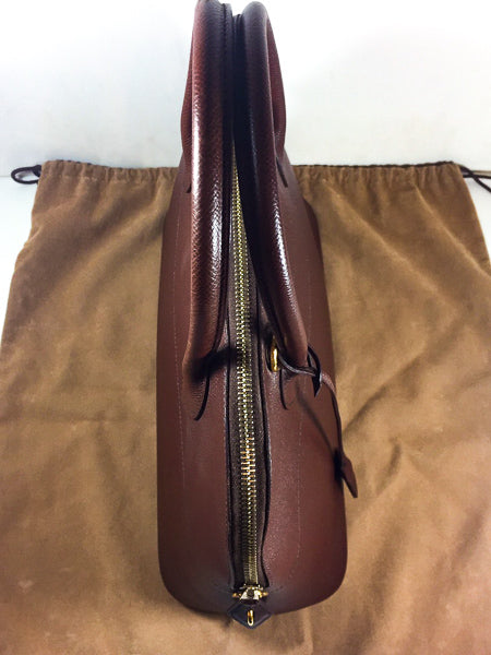 A rare mid century vintage Hermes travel bag in a mid tone brown leather  with two top handles and a brass Eclair zipper with leather pull (up until  the 90s Eclair zippers